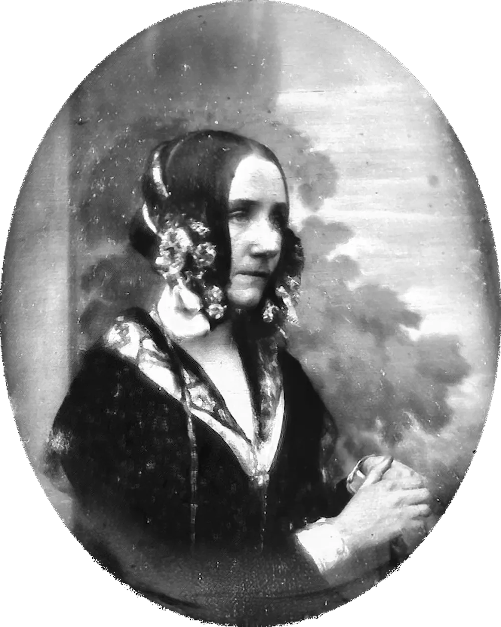 Black and white portrait of a young woman with hair accessories.